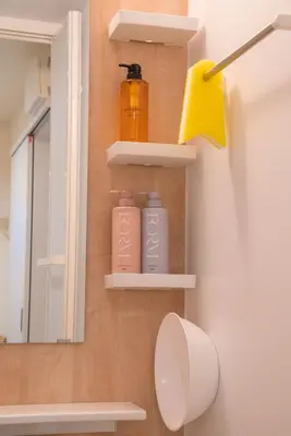 a bathroom with shelves and a toilet and a mirror at HoshiyoriTokyo in Tokyo