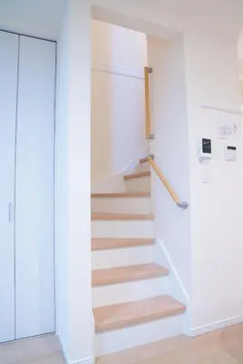 a staircase in a room with white walls and wooden floors at HoshiyoriTokyo in Tokyo
