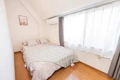 a bedroom with a bed and a large window at MDM Koiwa 2nd 303 2 bedrooms 5min from keisei koiwa station 60 min from Narita airport in Tokyo