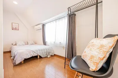 a bedroom with a bed and a chair and a window at MDM Koiwa 2nd 303 2 bedrooms 5min from keisei koiwa station 60 min from Narita airport in Tokyo