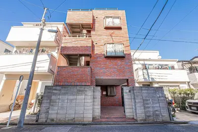 a tall brick building with two windows and a staircase at MDM Koiwa 2nd 303 2 bedrooms 5min from keisei koiwa station 60 min from Narita airport in Tokyo