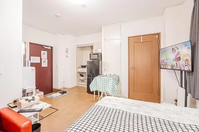 a living room with a table and a television in it at MDM Koiwa 2nd 303 2 bedrooms 5min from keisei koiwa station 60 min from Narita airport in Tokyo