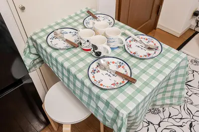 a table with a green and white checkered table cloth at MDM Koiwa 2nd 303 2 bedrooms 5min from keisei koiwa station 60 min from Narita airport in Tokyo