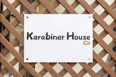 a sign for a karader house on a fence at Karabiner House Ikebukuro in Tokyo
