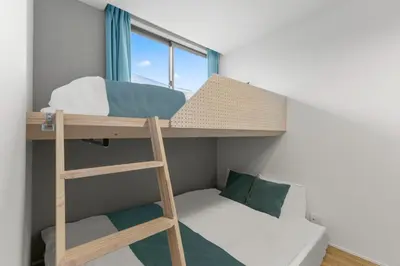 a bunk bed with a ladder and a couch in a room at 3\u540d\u5bbf\u6cca \u897f\u65b0\u5bbf\u30a2\u30d1\u30fc\u30c8\u30e1\u30f3\u30c8 in Tokyo