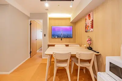 a dining room with a table and chairs and a tv at Komorebi Asakusa 202 Cozy 6P Stay The 77 House Tokyo in Tokyo