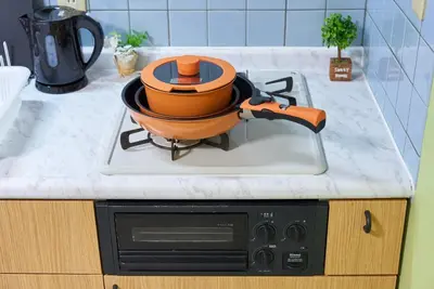 a pot on top of a stove in a kitchen at Shamrock Aoto 302 Cozy Tokyo Stay Near Station Airport Disney Access in Tokyo