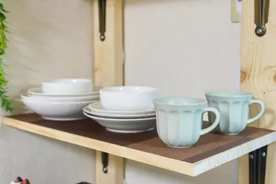 a shelf with three cups and plates on it at Shamrock Aoto 302 Cozy Tokyo Stay Near Station Airport Disney Access in Tokyo