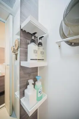 a shelf in a kitchen with soap and cleaning products at ERIKO HOTEL Azabujuban in Tokyo