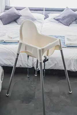 a white chair sitting in front of two beds at ERIKO HOTEL Azabujuban in Tokyo