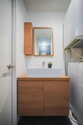 a bathroom with a sink and a mirror at ERIKO HOTEL Azabujuban in Tokyo