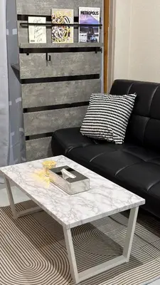 a white coffee table with a black couch and a table at Vibe Shibuya in Tokyo
