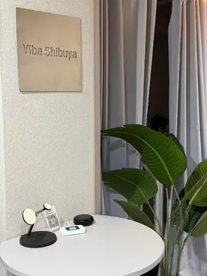 a white table in a room with a plant at Vibe Shibuya in Tokyo