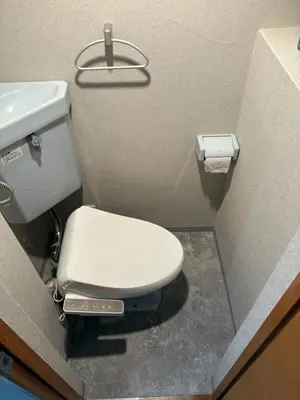 a bathroom with a white toilet and a sink at Vibe Shibuya in Tokyo