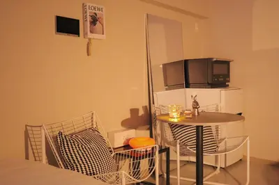 a small table and chairs in a small room at Vibe Shibuya in Tokyo