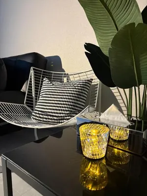a table with a chair and two lamps on it at Vibe Shibuya in Tokyo
