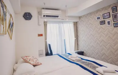 a bedroom with a white bed and a window at Yui Rin Asakusa 902 in Tokyo