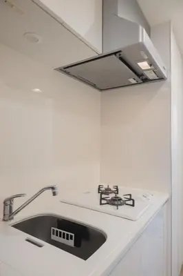 a white kitchen with a sink and a stove at Yui Rin Asakusa 902 in Tokyo