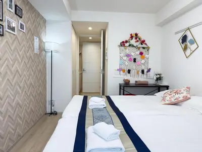 a bedroom with two beds with towels on them at Yui Rin Asakusa 902 in Tokyo