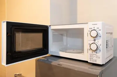 a microwave oven sitting on top of a refrigerator at StylishApartment 4Bds5p SkyTree5m Asakusa9m in Tokyo