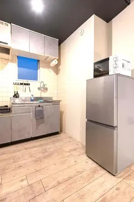 a kitchen with stainless steel appliances and wooden floors at StylishApartment 4Bds5p SkyTree5m Asakusa9m in Tokyo