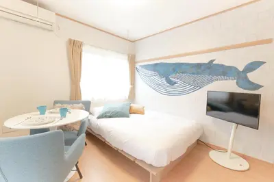a room with a bed and a tv and a table at monthly \u30c9\u30df\u30fc\u30eb\u4e16\u7530\u8c37 in Tokyo
