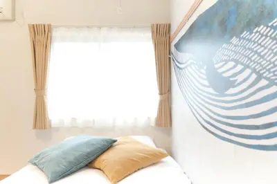 a bedroom with a baseball mural on the wall at monthly \u30c9\u30df\u30fc\u30eb\u4e16\u7530\u8c37 in Tokyo