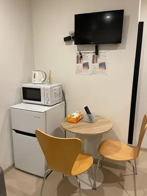 a kitchen with a small table and a microwave at Shin-Okubo, Shinjuku's best central location, private bathroom and toilet in Tokyo