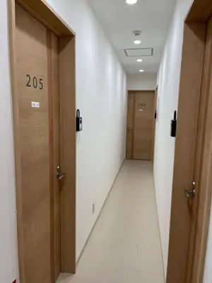 a corridor of a hospital hallway with wooden doors at Shin-Okubo, Shinjuku's best central location, private bathroom and toilet in Tokyo