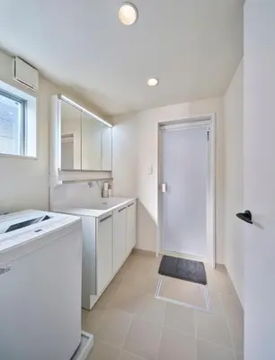 a white bathroom with a sink and a door at 7C's HOUSE in Tokyo