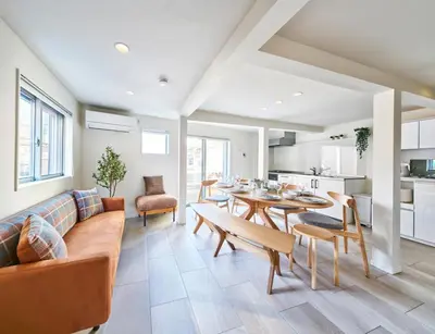 a living room with a couch and a table at 7C's HOUSE in Tokyo