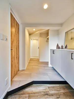 an empty hallway with a staircase and a door at 7C's HOUSE in Tokyo