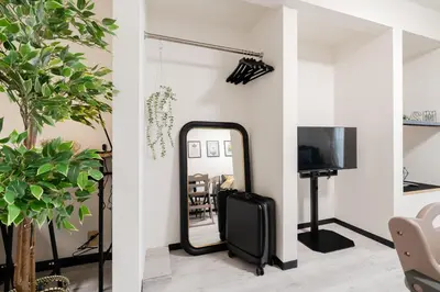 a mirror in a living room next to a tv at 3-chome House Senju - Entire Private Home - Direct Access to Ueno & Asakusa in Tokyo