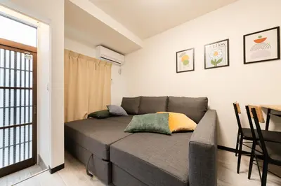 a living room with a couch and a table at 3-chome House Senju - Entire Private Home - Direct Access to Ueno & Asakusa in Tokyo