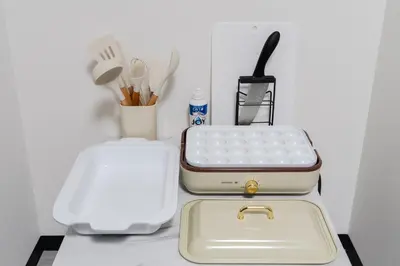a suitcase sitting on a counter next to a container of utensils at 3-chome House Senju - Entire Private Home - Direct Access to Ueno & Asakusa in Tokyo
