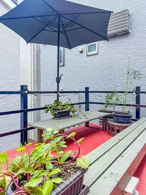 a picnic table with an umbrella on a balcony at 7-minute walk from Otsuka Station,Yamanote Line 3-person Shared garden in Tokyo