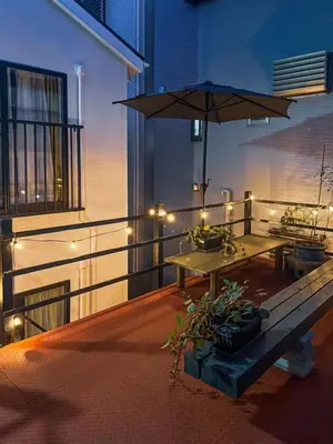 a patio with a table and an umbrella on a balcony at 7-minute walk from Otsuka Station,Yamanote Line 3-person Shared garden in Tokyo