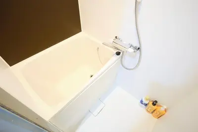 a bathroom with a shower with a white tub at monthly HJ PLACE TAKANAWA in Tokyo