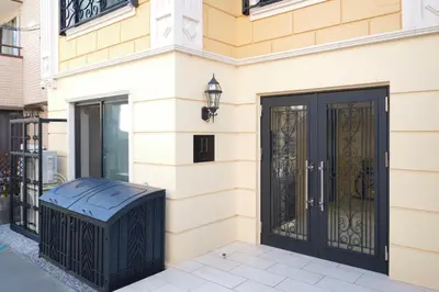 a front door of a house with a black gate at monthly HJ PLACE TAKANAWA in Tokyo