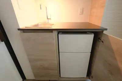 a small kitchen with a sink and a small refrigerator at monthly HJ PLACE TAKANAWA in Tokyo
