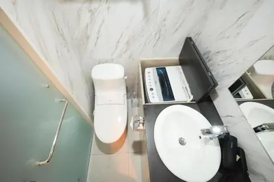 a bathroom with a white sink and a toilet at monthly HJ PLACE TAKANAWA in Tokyo