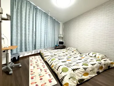 a bedroom with two beds and a large window at Spacious 3BR house 6 mins to JR Koiwa Station in Tokyo