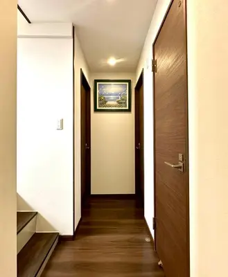 a hallway with a door and a picture on the wall at Spacious 3BR house 6 mins to JR Koiwa Station in Tokyo