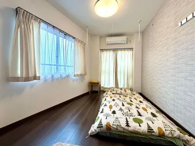 a bedroom with a bed and a large window at Spacious 3BR house 6 mins to JR Koiwa Station in Tokyo