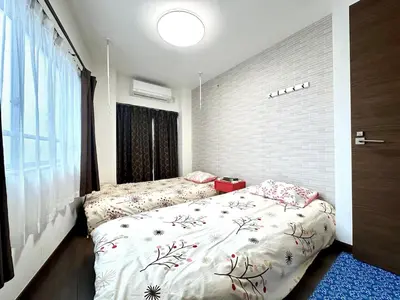 a bedroom with two beds and a window at Spacious 3BR house 6 mins to JR Koiwa Station in Tokyo