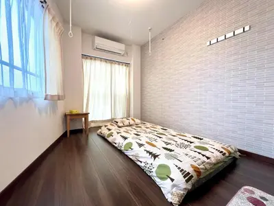 a bedroom with a bed in the corner of a room at Spacious 3BR house 6 mins to JR Koiwa Station in Tokyo