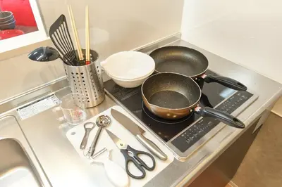 a kitchen counter with a stove with a pot on it at monthly J-ARC\u65b0\u5bbf in Tokyo