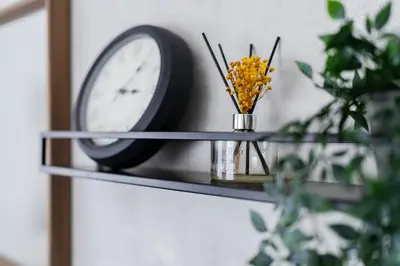a shelf with a clock and a vase of flowers at KOTOBUKI House - Perfect for Groups - 3 Bedrooms, 3 Baths in Tokyo