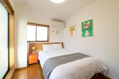 a bedroom with a white bed and a window at Yotsuya Lantern - Private 3 stories house for family in Tokyo