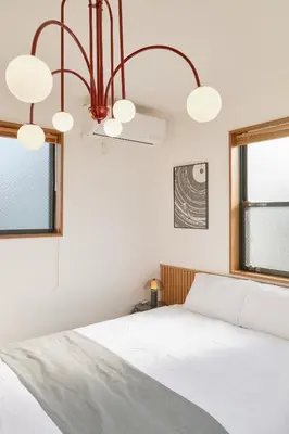 a bedroom with a white bed and a window at Yotsuya Lantern - Private 3 stories house for family in Tokyo